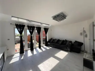 a living room with a couch and a large window at Z&Z Villa in Moffat