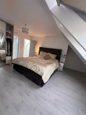 a bedroom with a large bed in a attic at Z&Z Villa in Moffat