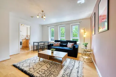 a living room with a couch and a table at 2BR Flat Parking Near City and Finnieston in Glasgow