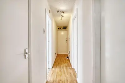 an empty hallway with white walls and wooden floors at 2BR Flat Parking Near City and Finnieston in Glasgow