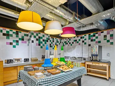 a kitchen with a table with food and colorful lights at ibis Styles Glasgow Centre George Square in Glasgow