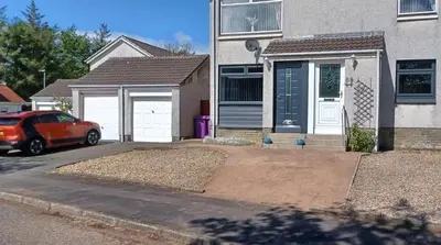 a house with a car parked in front of it at Modern flat in quiet residential cul-de-sac in Kilwinning