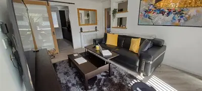 a living room with a couch and a table at Modern flat in quiet residential cul-de-sac in Kilwinning