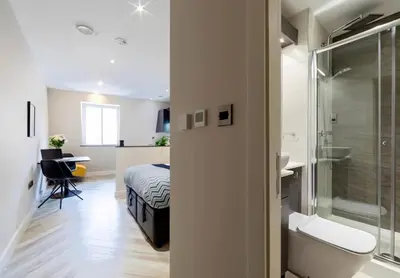 a bedroom with a bed and a bathroom with a shower at 121 Princess Street in Moffat