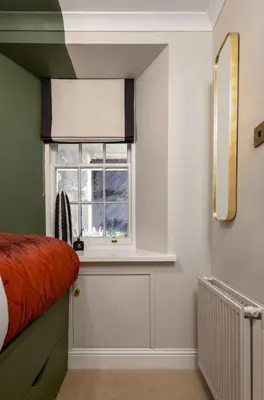 a bedroom with a window and a bed and a radiator at Emerald Suite, The Stirling Residence in Stirling