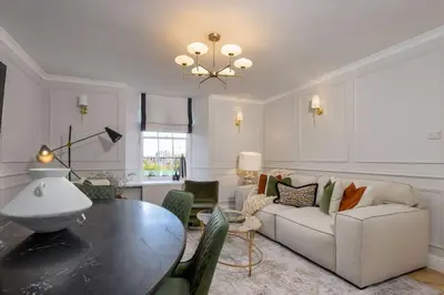 a living room with a table and a couch at Emerald Suite, The Stirling Residence in Stirling