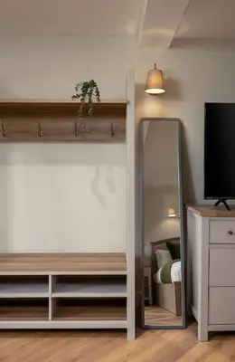 a bedroom with a mirror and a bed and a tv at Bridgend Studio - Near Free Parking in Stirling