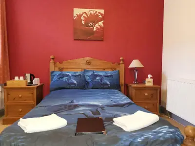 a bedroom with a bed with a laptop on it at Summer's Bay in Rothesay