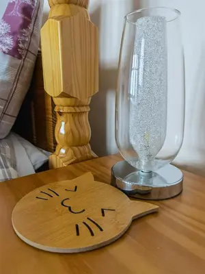 a wooden cutting board next to a glass on a table at Summer's Bay in Rothesay