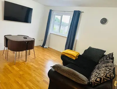 a living room with a couch and a table at Modern Apt commute to Edinburgh in Livingston