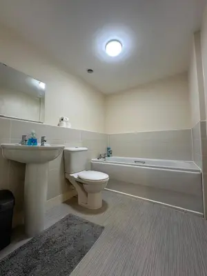 a bathroom with a toilet and a sink and a tub at 2 Bed & 2 Bath-Flat-Driving Distance to Edinburgh in Uphall