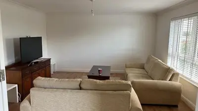 a living room with a couch and a tv at 2 Bed 2 Bath Flat 27Atholway in Uphall