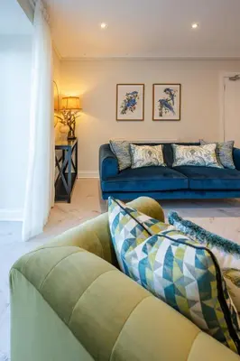 a living room with a couch and a table at Stirling Townhouse Apartment Btm in Stirling