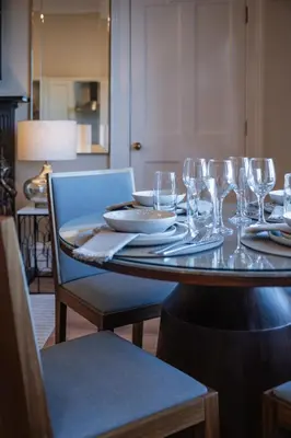a table with wine glasses on it with a tableablish at Stirling Townhouse Apartment Top in Stirling