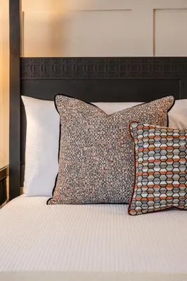 a bed with two pillows on top of it at Stirling Townhouse Apartment Top in Stirling