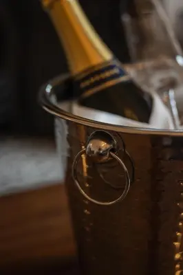 a metal bucket with a bottle of wine in it at Stirling Townhouse Apartment Top in Stirling