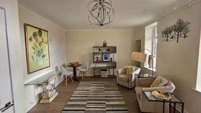 a living room with a couch and a table at Harbour Havens Apartments in Moffat
