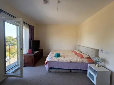 a bedroom with a bed and a sliding glass door at City Getaway - Homestay in Edinburgh