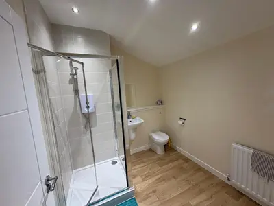 a bathroom with a shower and a toilet at City Getaway - Homestay in Edinburgh