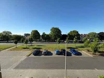 a parking lot with parked cars in a parking lot at City Getaway - Homestay in Edinburgh