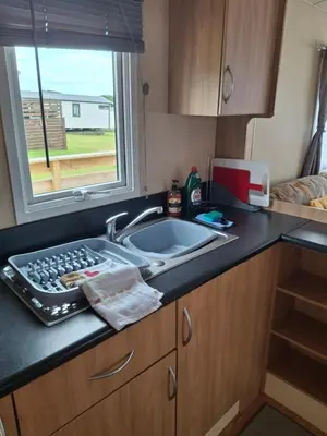 a kitchen counter with a sink and a window at The Coo Shed 94 in Newton Stewart