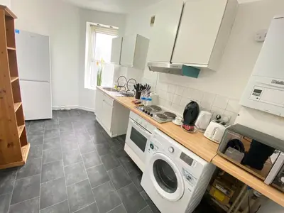 a kitchen with a washer and a washing machine at Luxurious 3 rooms greater London in Moffat