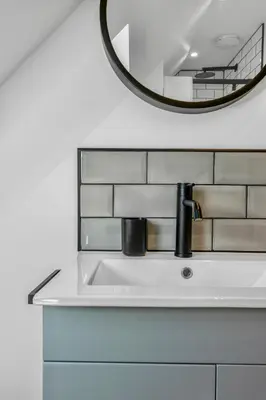 a bathroom with a sink and a mirror at Edinburgh's Springtime Chalet in Roslin