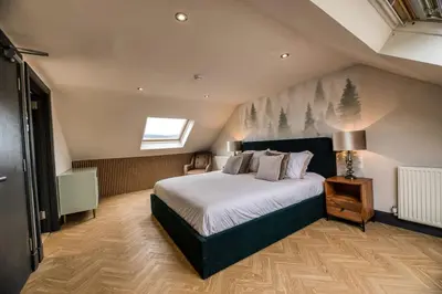 a bedroom with a large bed and a window at Fergus in ApartNest Auchterarder in Auchterarder