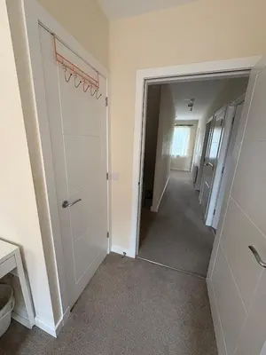 a hallway of a house with a mirror at Cosy Room with Shared Bathroom in Edinburgh