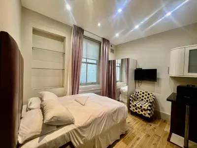 a bedroom with a white bed and a window at Collingham Road in Moffat