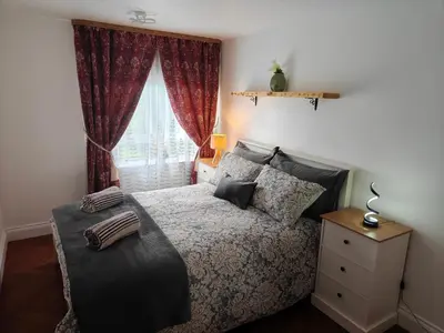 a bedroom with a bed and a window at Modern 2 Bed Flat in East Kilbride