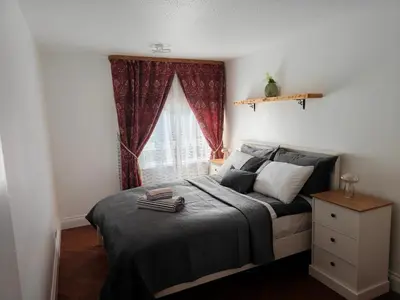 a bedroom with a bed and a window at Modern 2 Bed Flat in East Kilbride