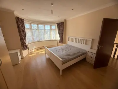 a bedroom with a bed and a large window at Harrow Inn Rooms in Yarrow