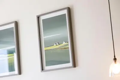 a picture frame hanging on a wall next to a mirror at Retreat to the Campsies in Lennoxtown