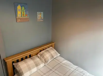 a small bed in a corner of a bedroom at Kames Bay Couples Retreat in Millport