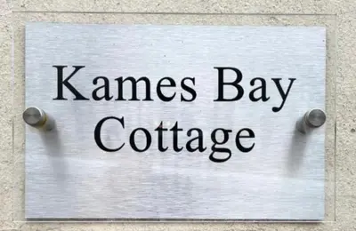 a sign that says names bay coffee on a wall at Kames Bay Couples Retreat in Millport