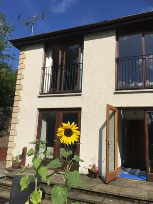 a sunflower is in front of a house at Riverside House in Callander