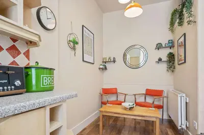 a living room with two chairs and a table at Stunning 2BR Apt - Central, Argyll Square Views in Oban