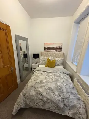 a bedroom with a bed and a mirror at Cosy Double Bedroom in Little Venice, Maide Vale in Moffat