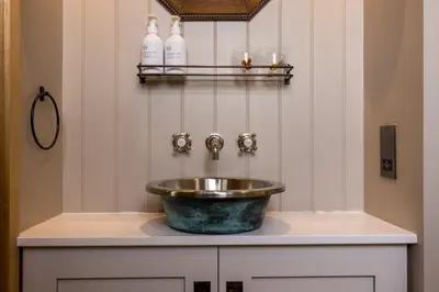 a bathroom with a bowl sink on a counter at Luxury Wood panelled West End GF Flat in Edinburgh