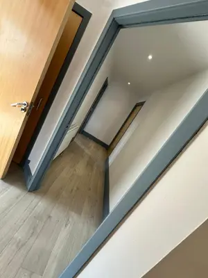 a sliding glass door in a room with wood floors at Old Town Place in Edinburgh