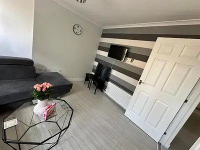 a living room with a couch and a door at Old Town Place in Edinburgh