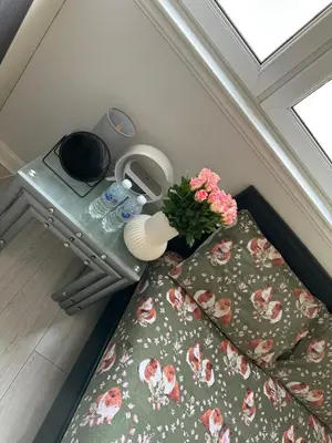 a bedroom with a bed and a table with flowers at Old Town Place in Edinburgh