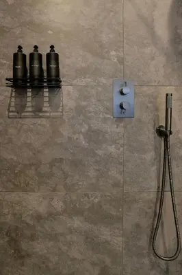 a bathroom with three black cameras on a wall at Modern apartment in town centre in Oban