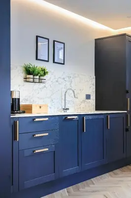 a kitchen with blue cabinets and a sink at Modern apartment in town centre in Oban