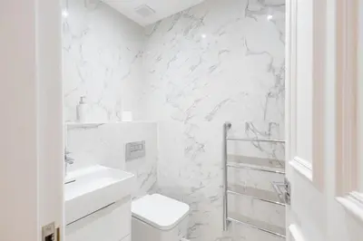 a white bathroom with a toilet and a sink at 3BR Gem West End Walk to Glasgow Uni Parking in Glasgow