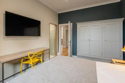 a room with a desk and a yellow chair at 3BR Gem West End Walk to Glasgow Uni Parking in Glasgow
