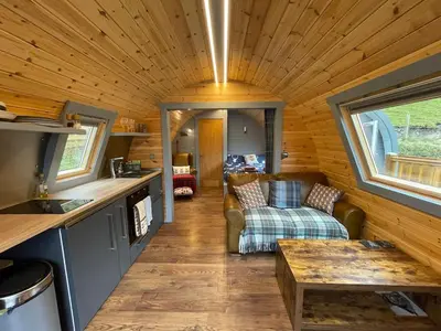 a kitchen and living room in a tiny house at Luxury Pod and Sauna with Fantastic Sea Views in Oban