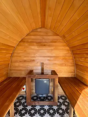 a small tv in a room with a wooden ceiling at Luxury Pod and Sauna with Fantastic Sea Views in Oban