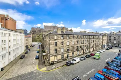 a city with buildings and cars parked in a parking lot at Grindlay St - Fantastic 2BR in Theatre District in Edinburgh
